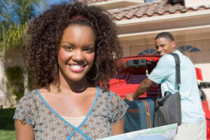 Man And Women Packing Bag In Car