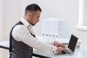 Man Working With Laptop At Table