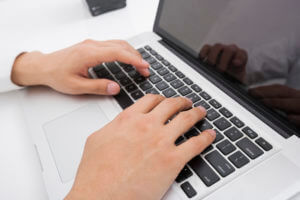 Close-up Top View Of Man Working On Laptop