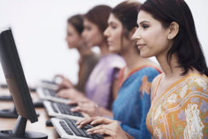 Side View Of Womens Working On Computer