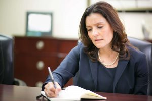 Woman Wearing Black Dress And Writing Notes In Diary